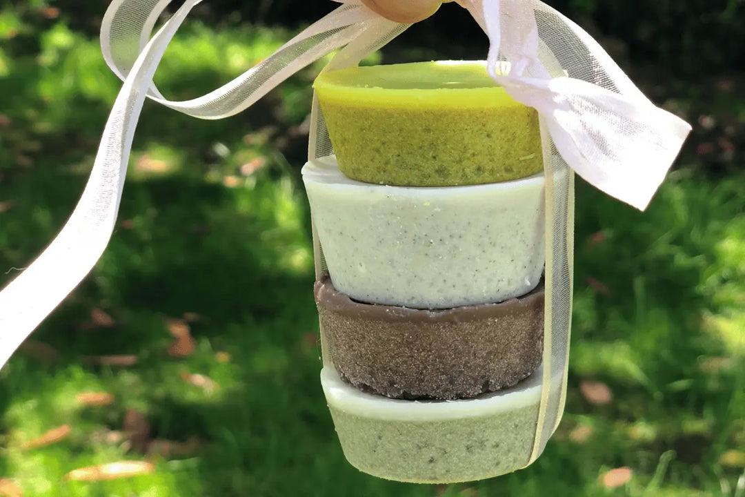 Make Your Own four natural colours Skin Scrubs Go Native NZ Recipe Stacked and tied with a ribbon, in green surrounds and sunshine 