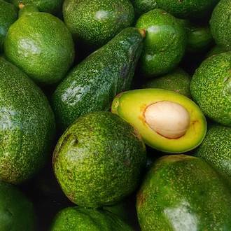 green avocados piled together ready to make Go Native NZ's extta virgin avocado carrier oil