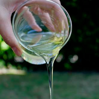 Liquid Castle Soap dripping out of a glass beaker