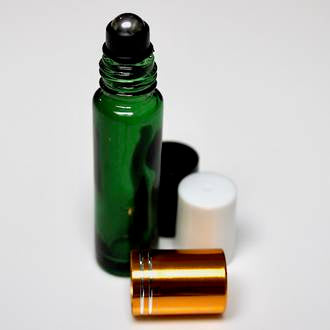 Green glass roll-on, with stainless steel ball. Choices of gold, black, white caps on table top. Empty for DIY perfume 