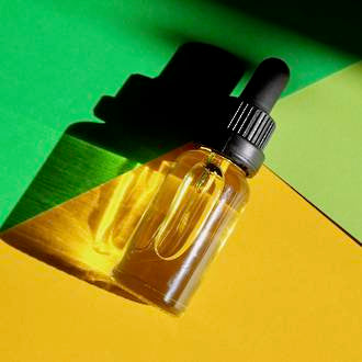 Vitamin C skin revival serum, made by Go Native NZ in bottle, on bright green and yellow background